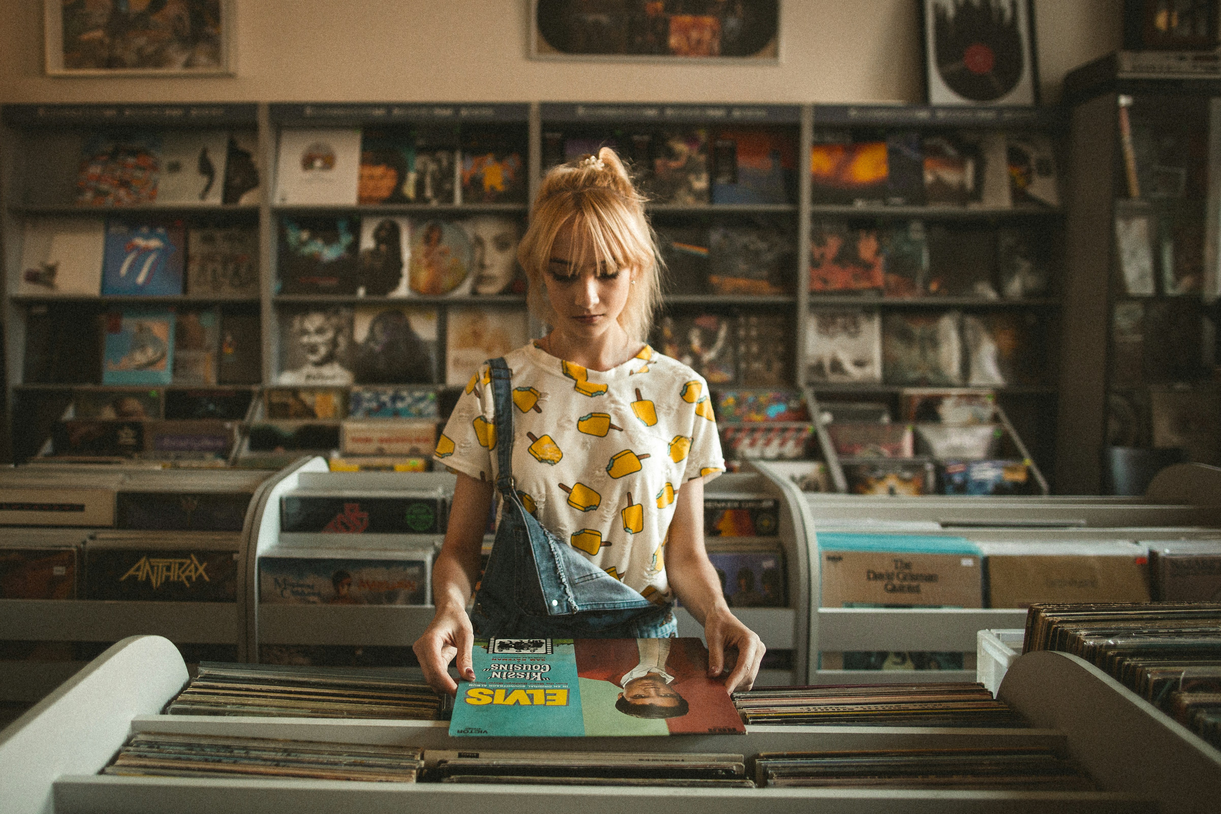 Person browsing vinyl records in a record shop